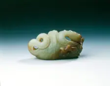 Jade five-clawed dragon with feathered tail in cloth wrapping, late Ming dynasty, China, 1550-1644. Creator: Unknown