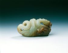 Jade five-clawed dragon with feathered tail in cloth wrapping, late Ming dynasty, China, 1550-1644