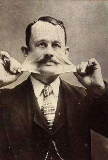 James Morris, stretching the skin on his face. Creator: Unknown