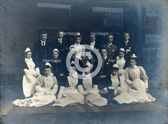 James Rutherford Morison with his staff: seven men and nine women, c1900. Creator: Unknown.