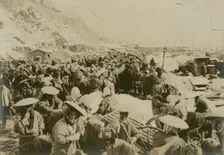 Japanese and Korean coolies removing supplies from wharf of Chemulpo, c1904. Creator: Robert Lee Dunn