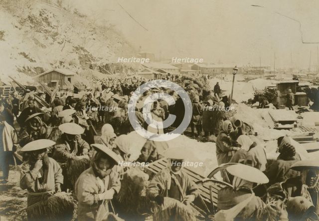 Japanese and Korean coolies removing supplies from wharf of Chemulpo, c1904. Creator: Robert Lee Dunn.