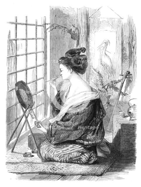 Japanese girl painting her lips, 1864. Creator: Mason Jackson.