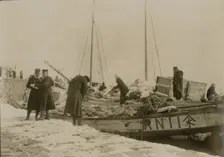 Japanese officers directing the unloading of supplies, Chemulpo, c1904. Creator: Robert Lee Dunn