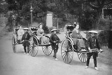 Japanese ladies in rickshaws drawn by coolies, 1902