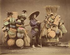 [Japanese Man Posing with Baskets, Brooms and Feather Dusters], 1870s. Creator: Unknown