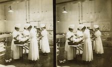 Japanese nurses attending to a patient in an operating room, c1905. Creator: Underwood & Underwood