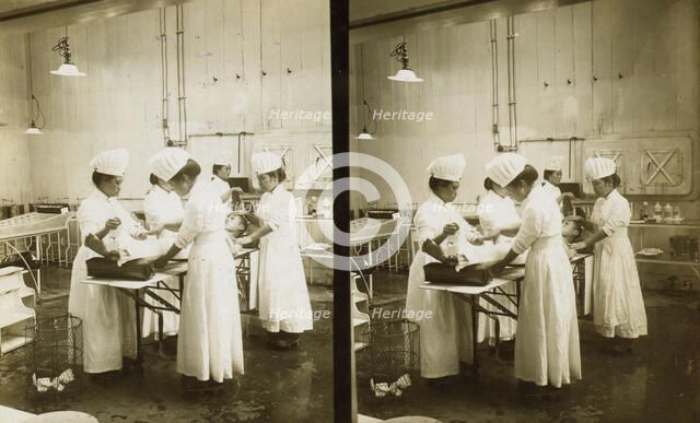 Japanese nurses attending to a patient in an operating room, c1905. Creator: Underwood & Underwood.