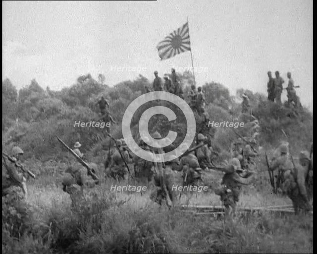 Japanese Soldiers Gathering Around the Japanese Flag, 1933. Creator: British Pathe Ltd.