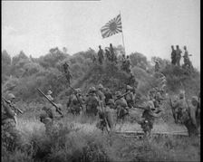 Japanese Soldiers Gathering Around the Japanese Flag, 1933. Creator: British Pathe Ltd