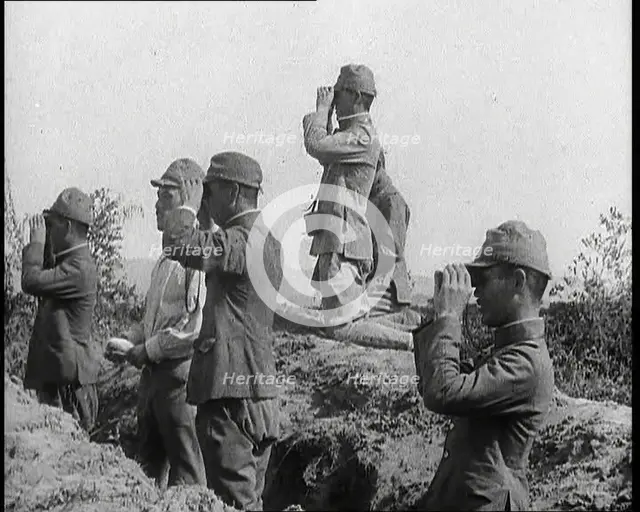 Japanese Soldiers in a Trench Looking Through Binoculars, 1937. Creator: British Pathe Ltd.
