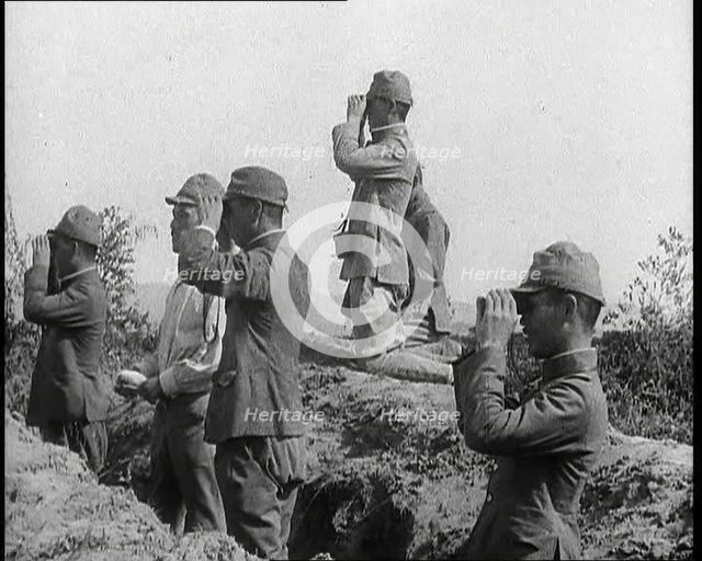 Japanese Soldiers in a Trench Looking Through Binoculars, 1937. Creator: British Pathe Ltd.