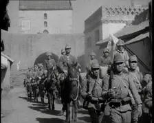 Japanese Soldiers Marching and Riding On Horseback Under an Arch and Through a Street..., 1937. Creator: British Pathe Ltd