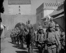 Japanese Soldiers Marching and Riding On Horseback Under an Arch and Through a Street..., 1937. Creator: British Pathe Ltd