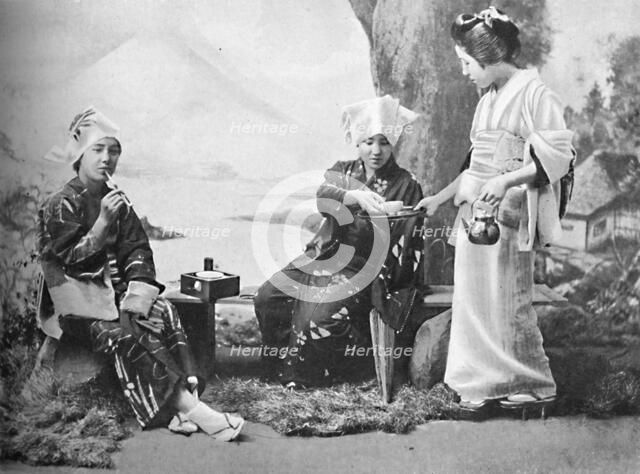 Japanese peasant girls taking tea at a wayside rest, 1902. Artist: Unknown.