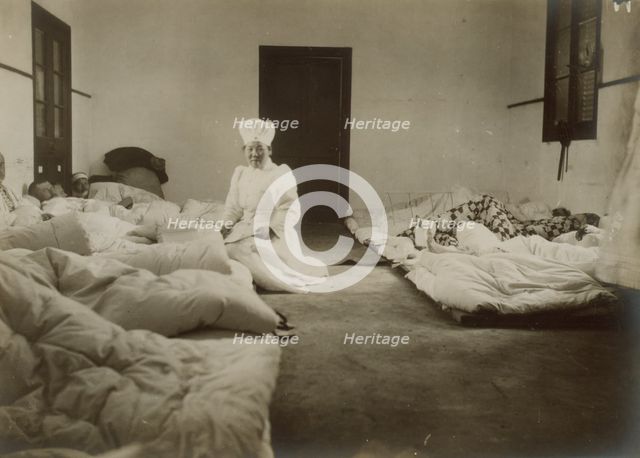 Japanese Red Cross nurses at Chemulpo attending Russian soldiers wounded in battle of Feb. 9, c1904. Creator: Robert Lee Dunn.
