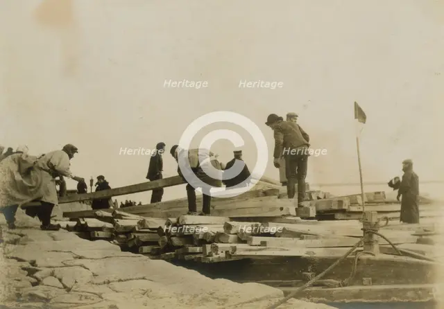 Japanese removing timbers from lighters at Chemulpo for erection of runways, c1904. Creator: Robert Lee Dunn.