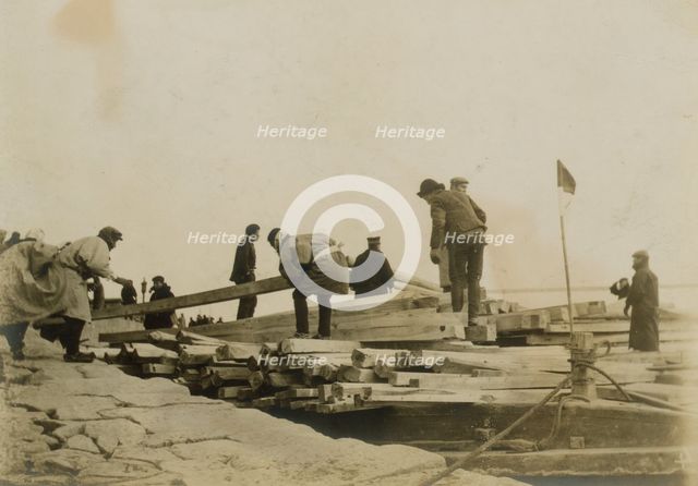 Japanese removing timbers from lighters at Chemulpo for erection of runways, c1904. Creator: Robert Lee Dunn.