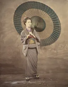 Japanese woman holding a large parasol, 1868-1880. Creator: Felice Beato