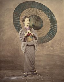 Japanese woman holding a large parasol, 1868-1880. Creator: Felice Beato