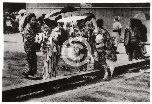 Japanese women by the Zeppelin hangar, Kasumigaura, Japan, 1929 (1933). Artist: Unknown