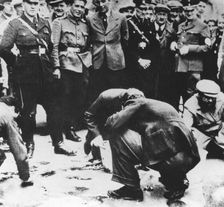 Jews are made to clean the streets of Vienna after the Anschluss, 1938