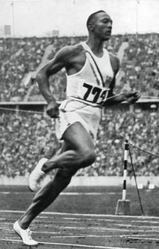 Jesse Owens at the end of the 100m at the Berlin Olympic Games, 1936
