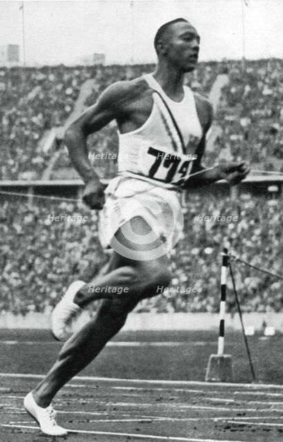 Jesse Owens at the end of the 100m at the Berlin Olympic Games, 1936. Artist: Unknown