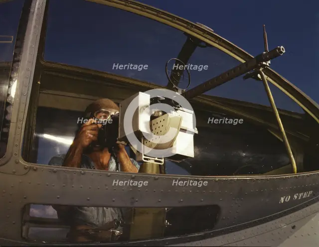 Jesse Rhodes Waller, A.O.M., third class, tries out a 30-calibre...Naval Air Base, Corpus..., 1942. Creator: Howard Hollem.