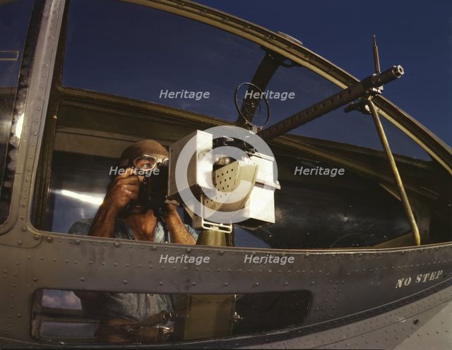Jesse Rhodes Waller, A.O.M., third class, tries out a 30-calibre...Naval Air Base, Corpus..., 1942. Creator: Howard Hollem.