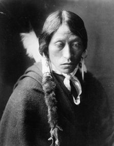 Jicarilla man, head-and-shoulders portrait, facing slightly right, with fur wrapped braids..., c1905 Creator: Edward Sheriff Curtis