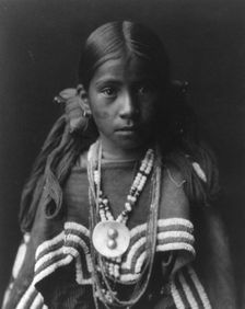 Jicarilla girl in feast dress, c1905. Creator: Edward Sheriff Curtis