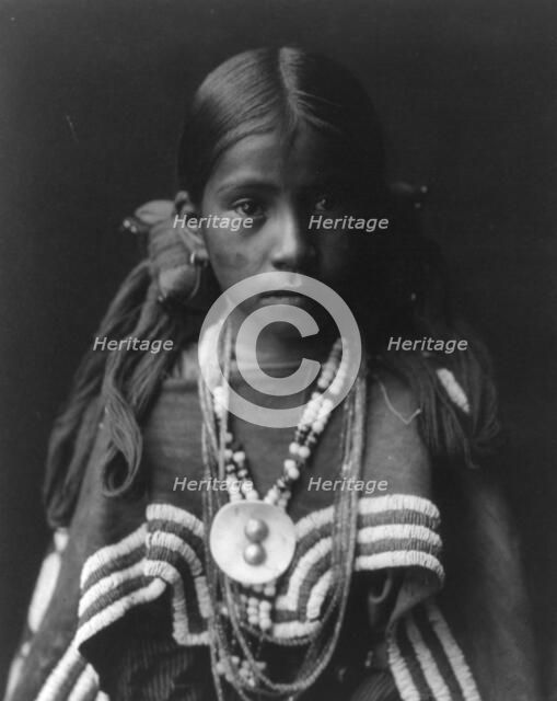 Jicarilla girl in feast dress, c1905. Creator: Edward Sheriff Curtis.