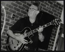 Jim Mullen playing guitar at The Fairway, Welwyn Garden City, Hertfordshire, 3 August 1997. Artist: Denis Williams