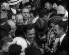 Jim Mollison Walking Surrounded by a Large Crowd, 1930s. Creator: British Pathe Ltd