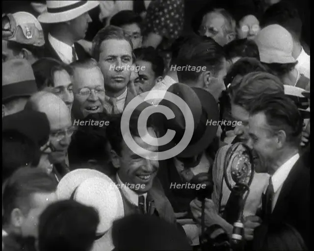Jim Mollison Walking Surrounded by a Large Crowd, 1930s. Creator: British Pathe Ltd.