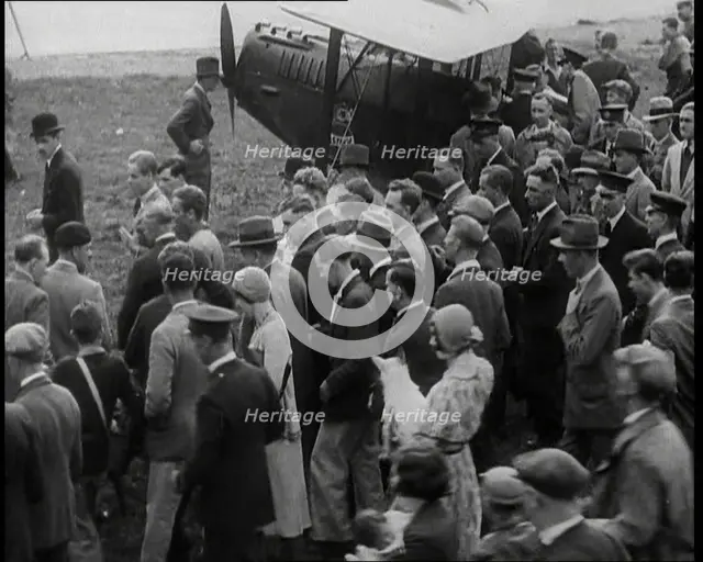 Jim Mollison Walking to His Plane With a Large Crowd, 1930s. Creator: British Pathe Ltd.