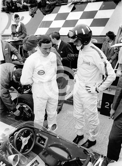 Jim Clark and Graham Hill in pits with Lotus 49 during 1967 British Grand Prix. Creator: Unknown.