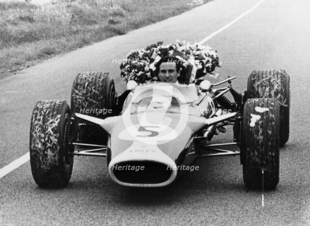 Jim Clark in a Lotus with the winner's laurel wreath. Artist: Unknown