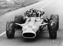 Jim Clark in a Lotus with the winner's laurel wreath