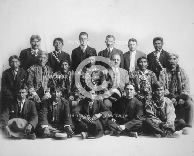 Judge James Wickersham in council with Indian chiefs, between 1900 and 1907. Creator: Unknown.