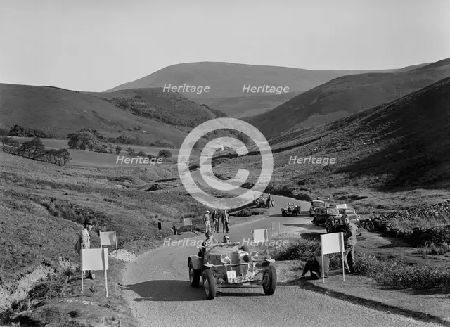 K Hutchison's winning Allard Special leading R Fielding's Jaguar SS at the Blackpool Rally, 1939. Artist: Bill Brunell.