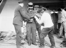 On KAISER WILHELM II - Buttoning up a fire-fighter, between c1910 and c1915. Creator: Bain News Service