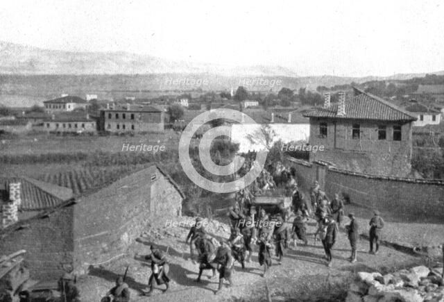On the Eastern Front; Our Zouaves cross Pogradec, at the southern end of Lake Ohrid..., 1917. Creator: Unknown.