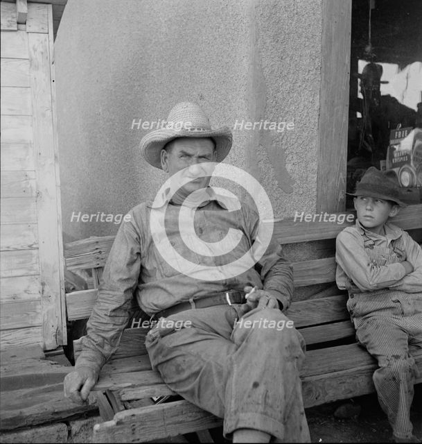 One of a group of western Oklahoma wheat farmers congregated at crossroads service station, 1938. Creator: Dorothea Lange.
