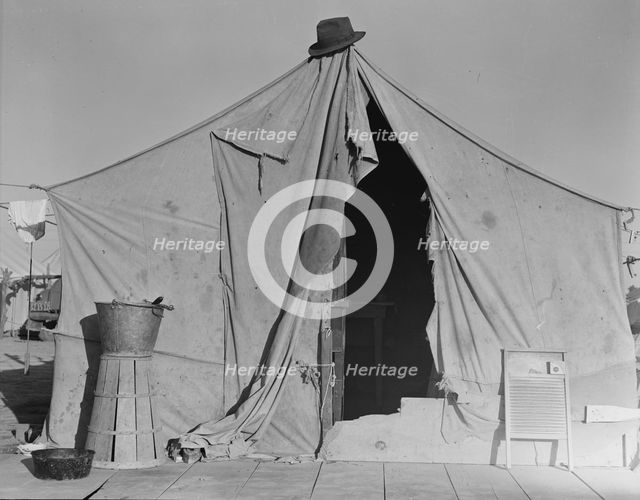 One of a row of tents, home of a pea picker, near Calipatria, Imperial Valley, CA, 1939. Creator: Dorothea Lange.