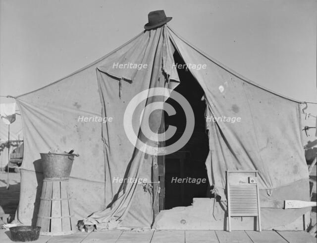 One of a row of tents, home of a pea picker, near Calipatria, Imperial Valley, California, 1939. Creator: Dorothea Lange.