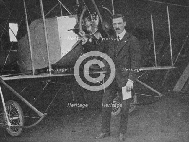 One of the best instructors: Lewis WF Turner standing by a Caudron training biplane, 1913 (1934). Artist: Flight Photo.