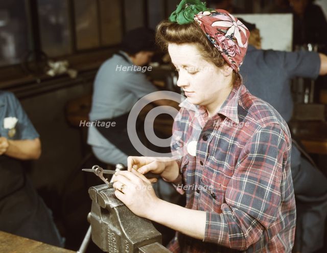 One of the girls of Vilter [Manufacturing] Co. filing small gun parts, Milwaukee, Wisc. , 1943. Creator: Howard Hollem.
