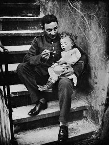 One of the New Army making himself useful in his billet 1915